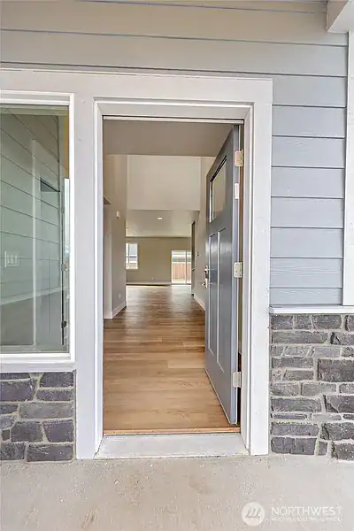 Newly built home entrance with open door and interior view.