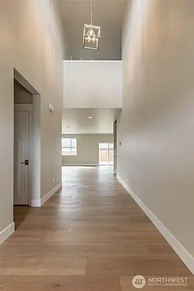 Spacious, bright hallway with high ceilings in West Ridge Home.